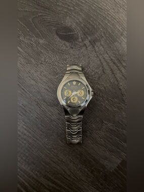 Silver Watch with Black Dial and Gold Accents